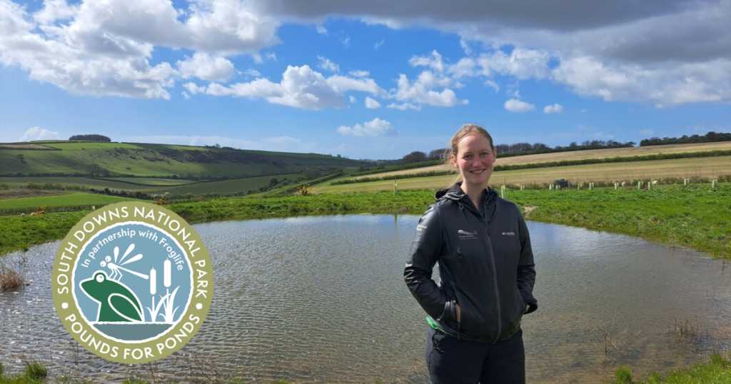 South Downs National Park ranger Sophie Brown standing by Peppering dew pond on the South Downs