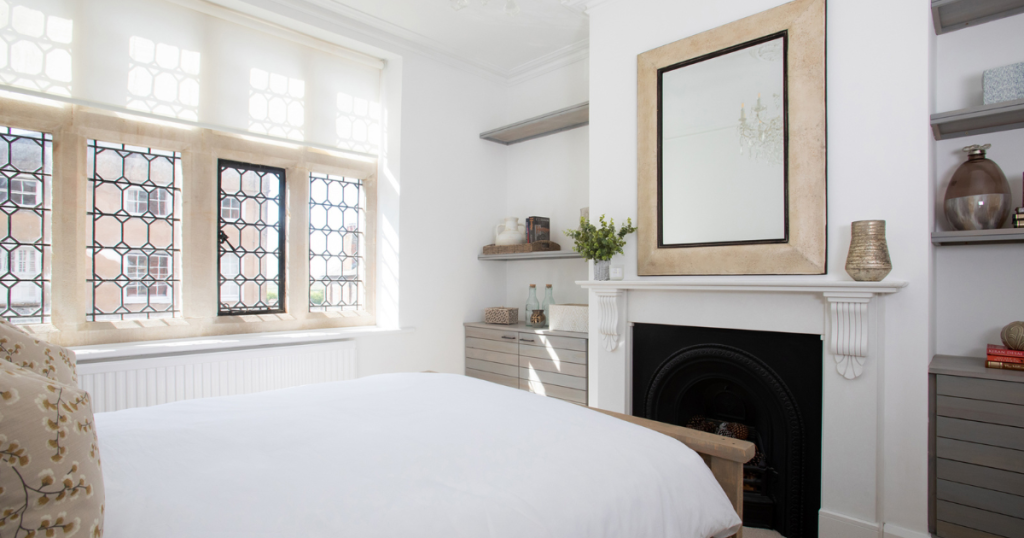 Image showing a beautifully decorated white bedroom with ornate windows