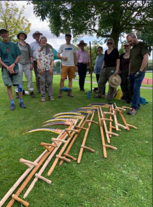 A group of volunteers getting ready to receive traditional scything skills from a CPRE Hampshire training session