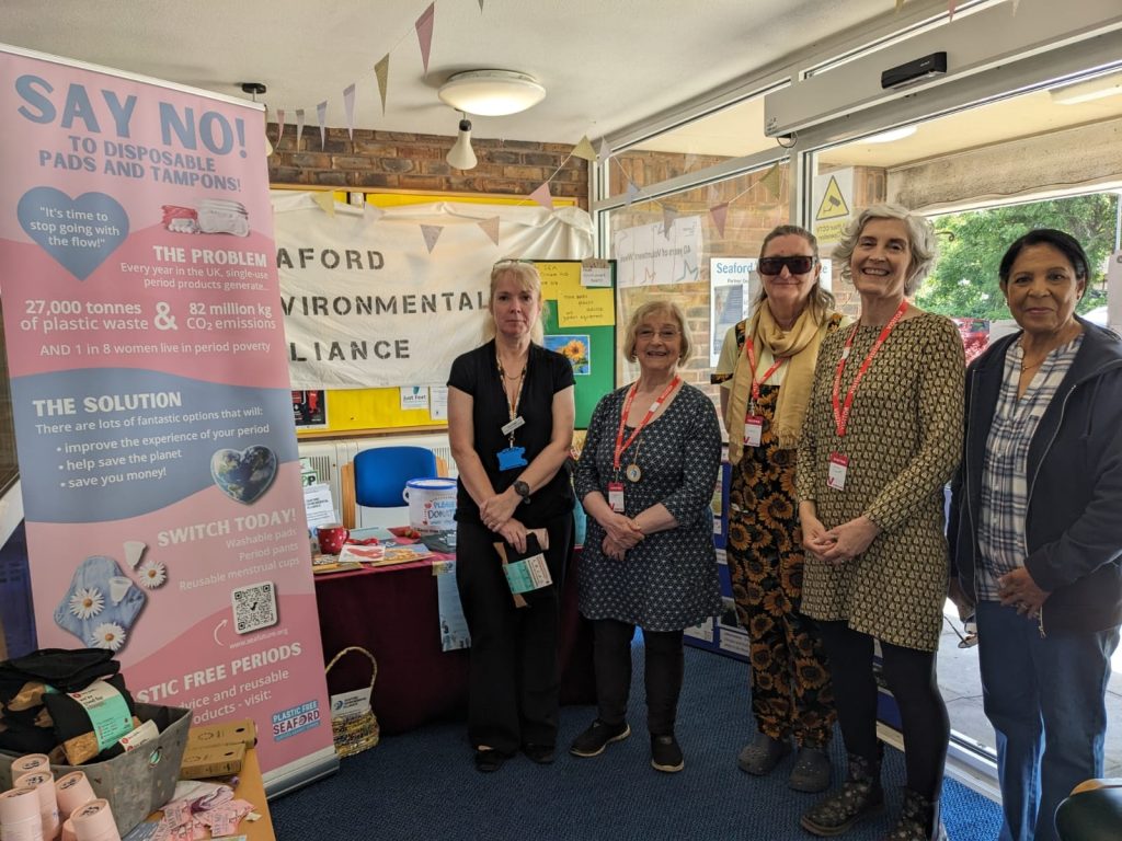 volunteers standing in front of a stall at a medical practice promoting plastic free periods for women as a sustainable option. 