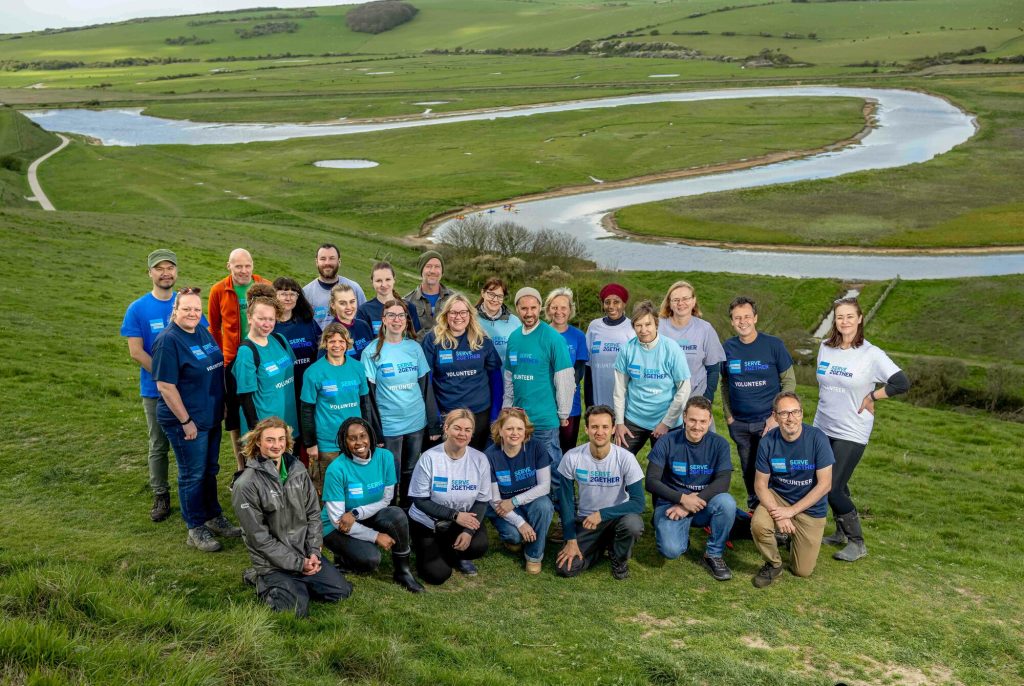 A group of volunteers from Amex gathered on the hillside at Seven Sisters overlooking the river Cuckmere