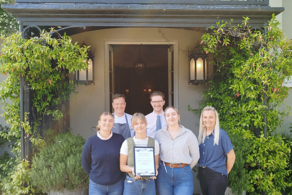 Staff from THE PIG in the South Downs displaying the certificate presented by South Downs National Park Trust.
